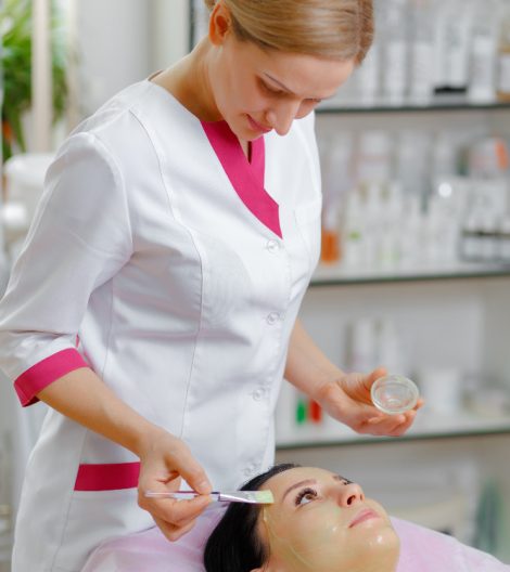 professional-woman-applying-green-cream-with-brush