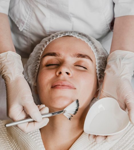 top-view-young-beautiful-woman-getting-face-skin-treatment